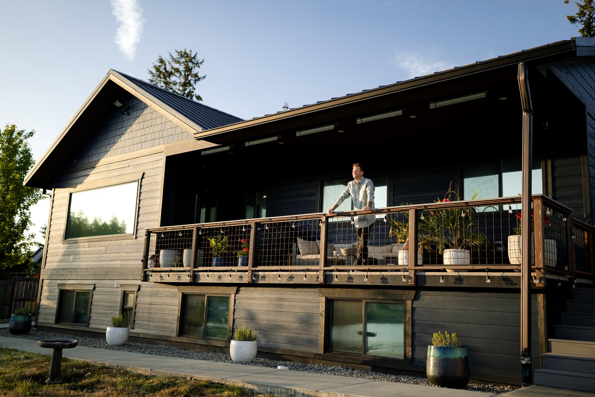Ron Rougeaux on the porch of a South Sound home at sunset
