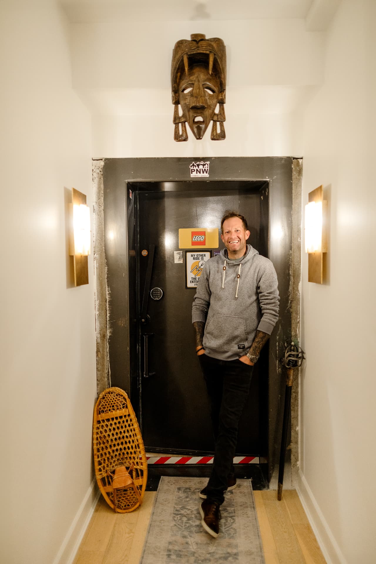 Ron Rougeaux standing by the vault door at the PNW Homes Group office