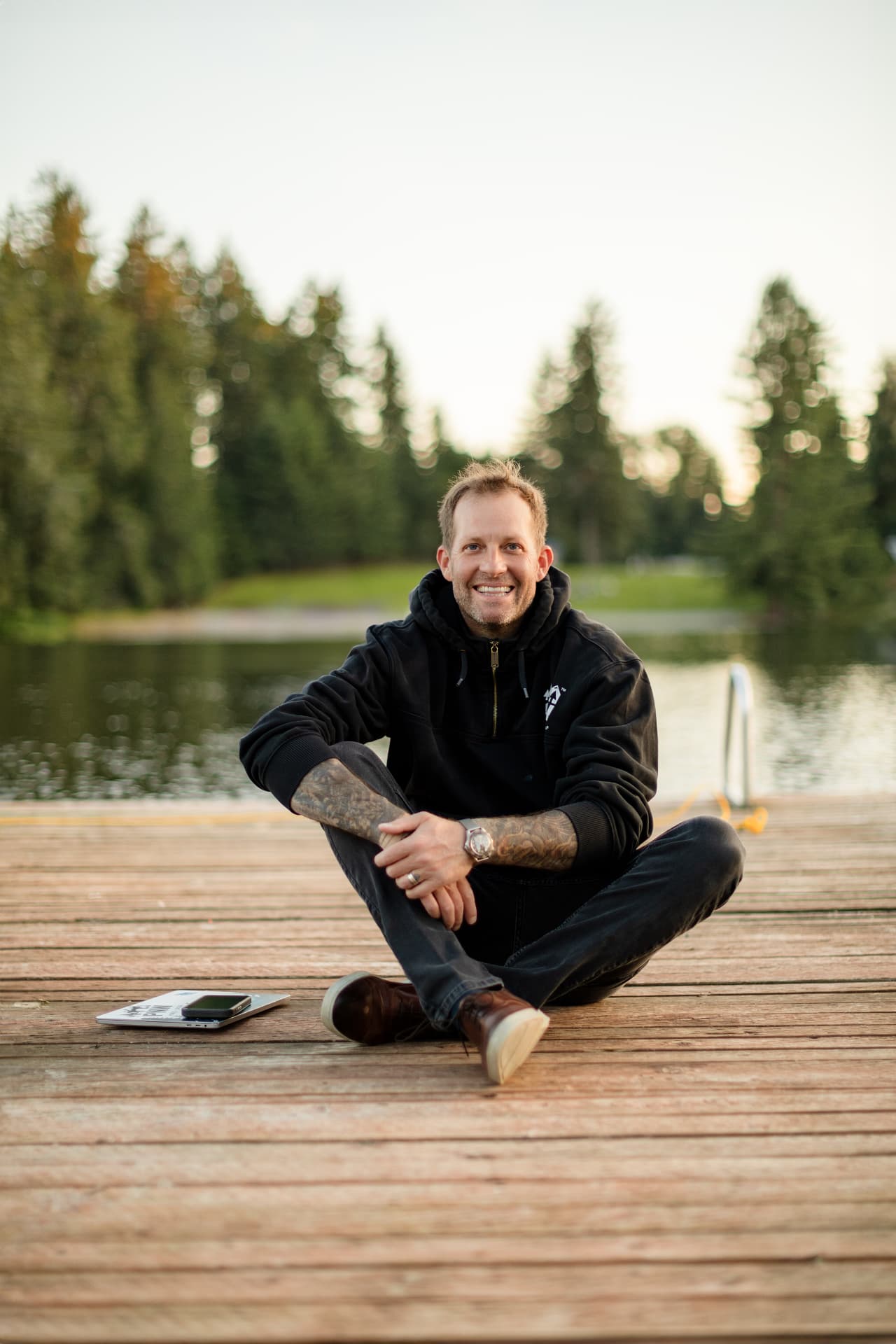 Ron Rougeaux sitting on a dock by the lake